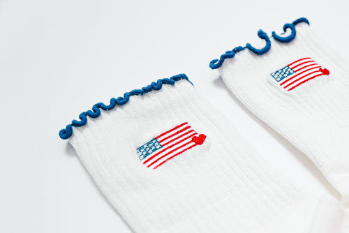 Socks with american flag design with small heart in the corner and navy blue ruffle tops