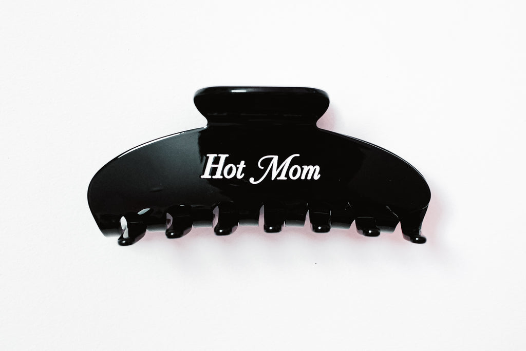 Black Claw Clip saying "Hot Mom" in white font over a white background.
