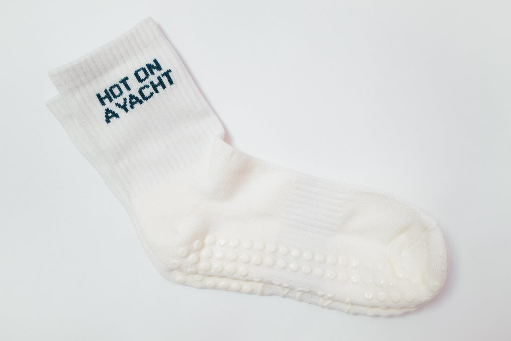 White grip sock with 'Hot on Yacht' text on a white background