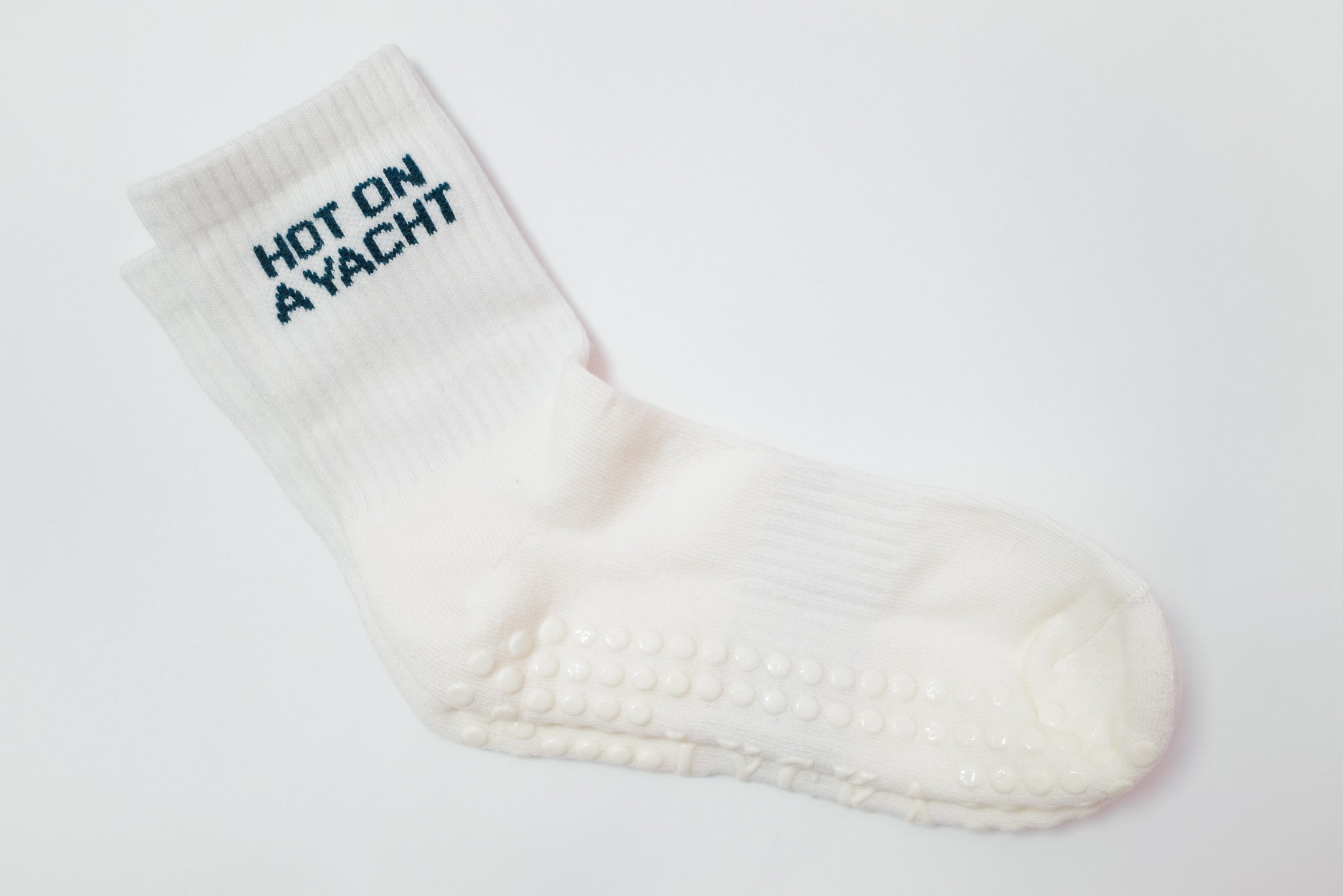 White grip sock with 'Hot on Yacht' text on a white background